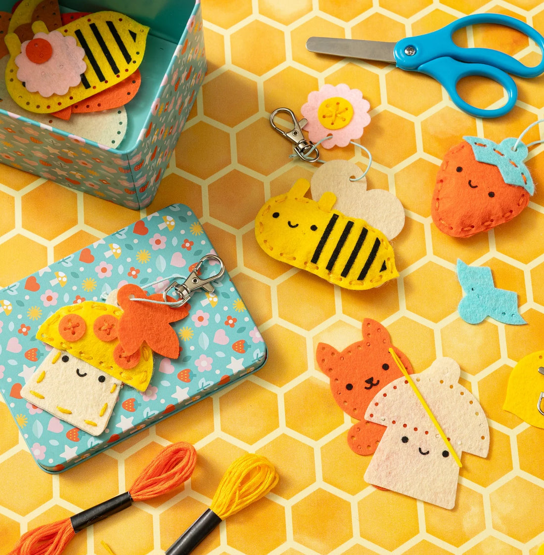 Piese din fetru, ațe, cutie metalică și brelocuri în lucru din setul Pocket Pal Bag Charms.